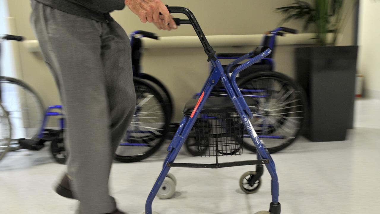 A man uses a walker to assist his mobility (file image)