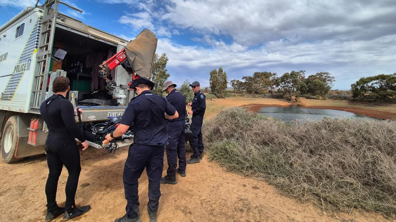Police divers search the dam (file image)