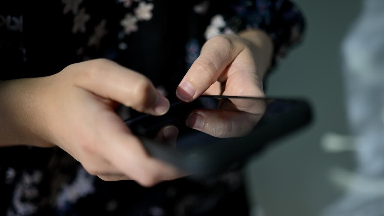 A person uses a mobile phone (file image)