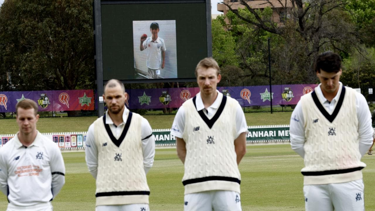 A photo of Ben Austin displayed on a screen behind shield players