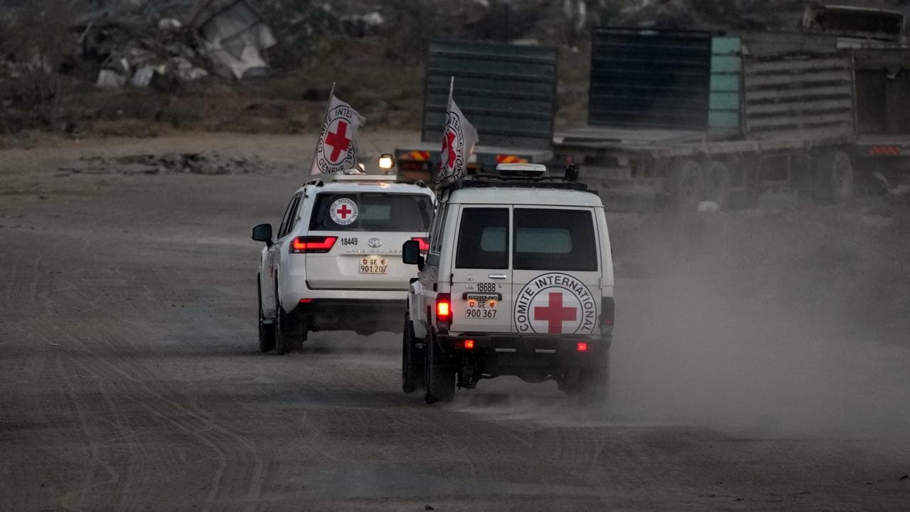 Red Cross vehicles carrying bodies believed to be dead hostages
