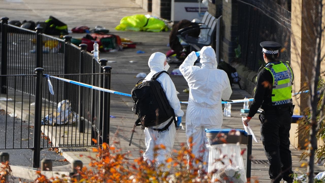 Forensic investigators after a mass stabbing on a train in Huntingdon