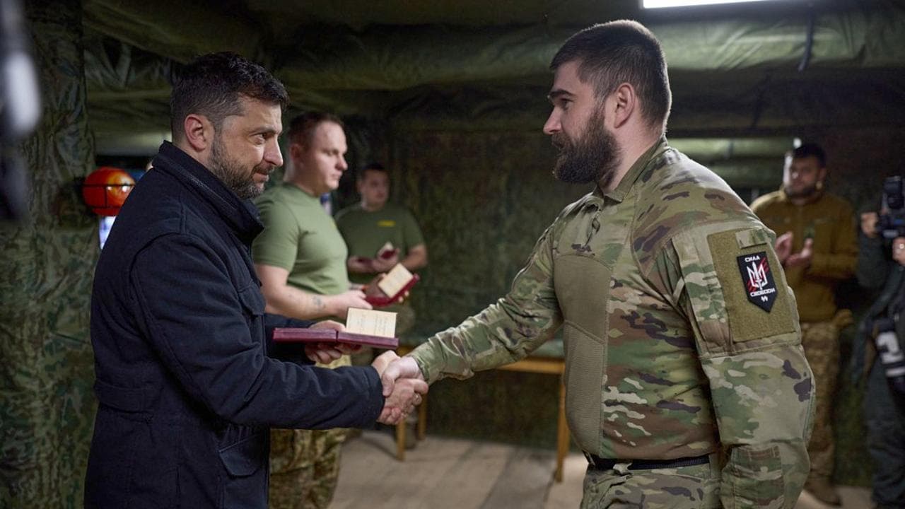 Volodymyr Zelenskiy and a soldier