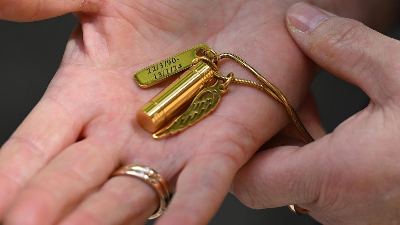 Tammy Gordon holding a necklace dedicated to her brother