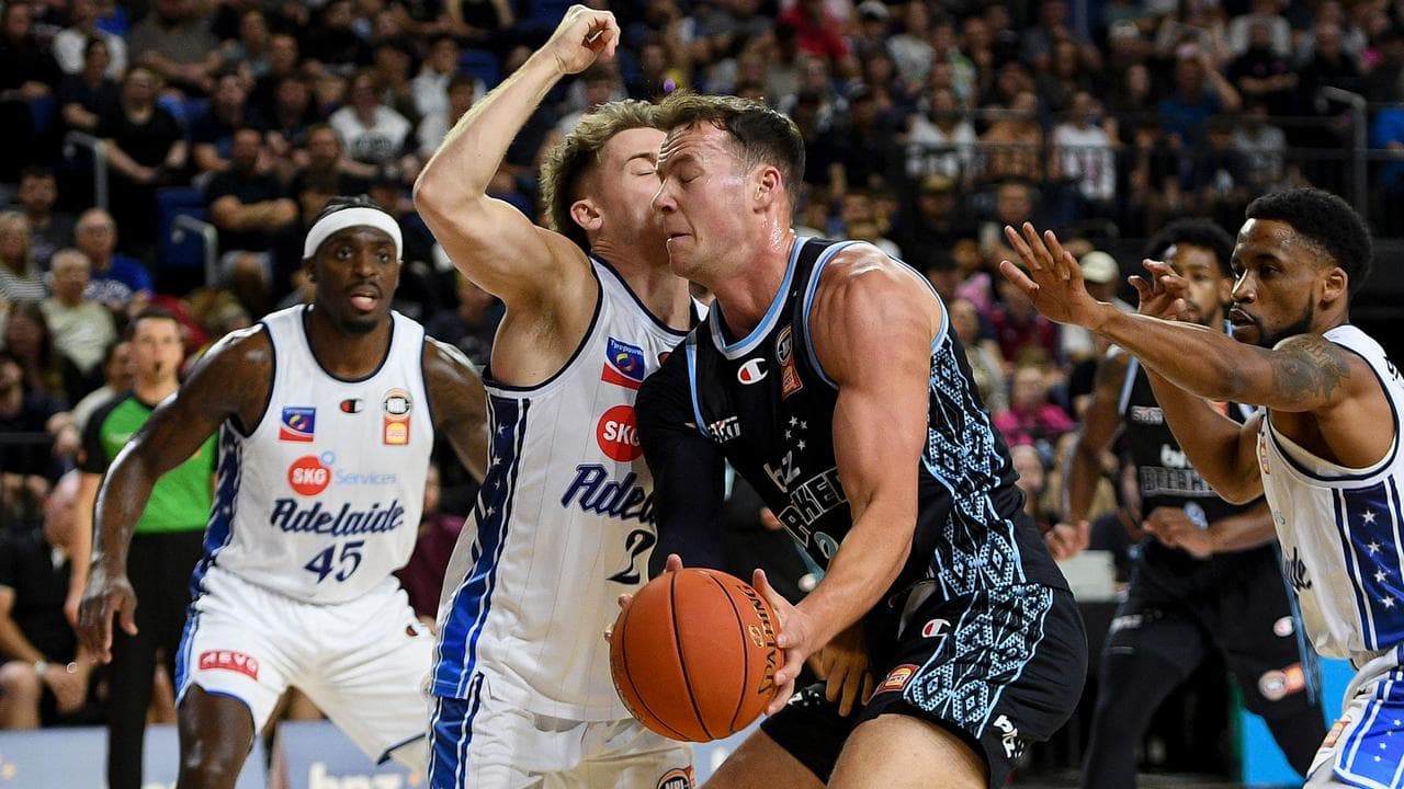 Sam Mennenga has a close encounter with Adelaide's Isaac White.