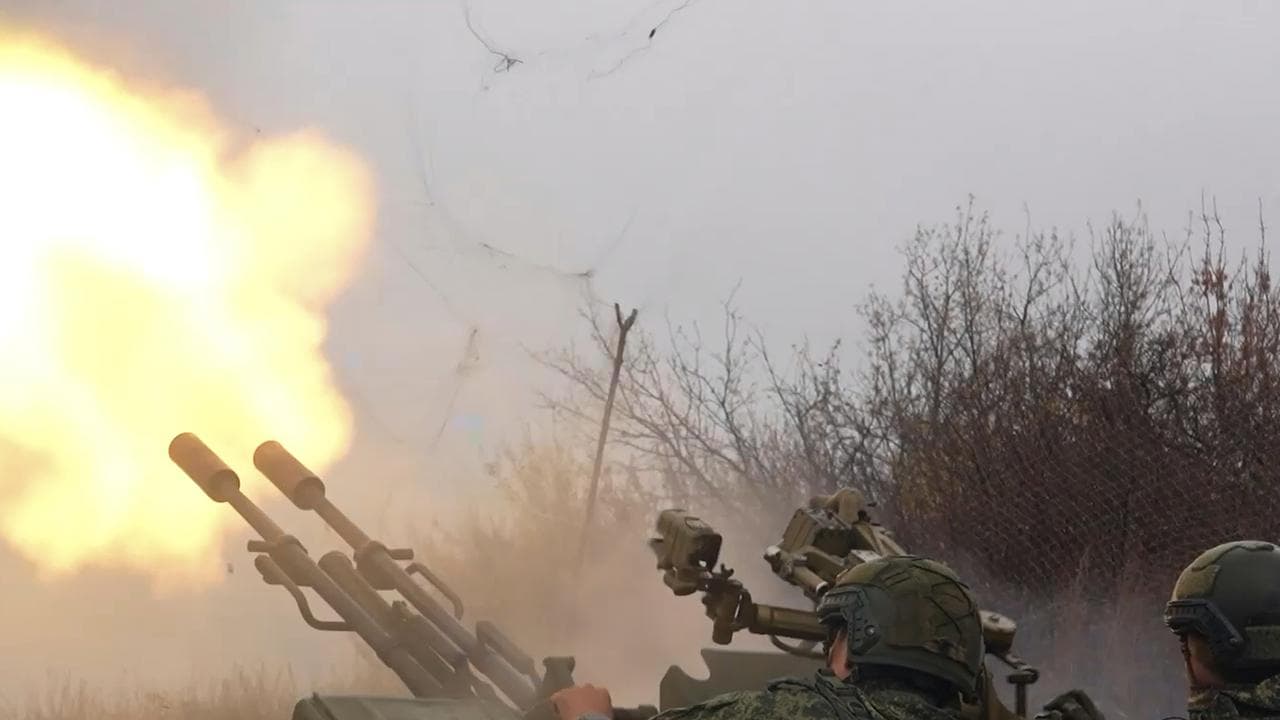 Russian army soldiers fire to shoot a Ukrainian drone