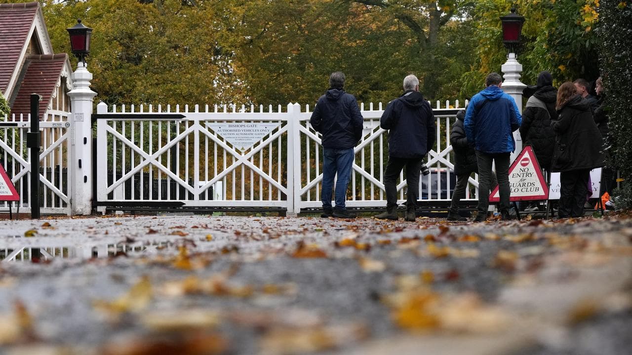 Journalists wait at an entrance near to the Royal Lodge,
