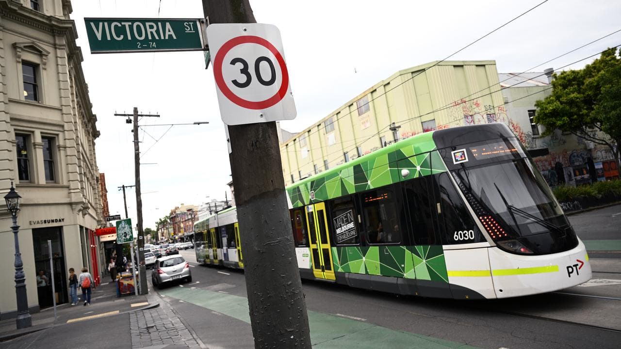 Tram passes a 30km speed limit sign in Fitzroy, Melbourne