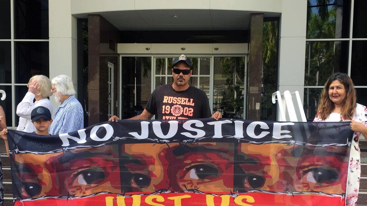 Protesters gather outside a hearing of the Royal Commission