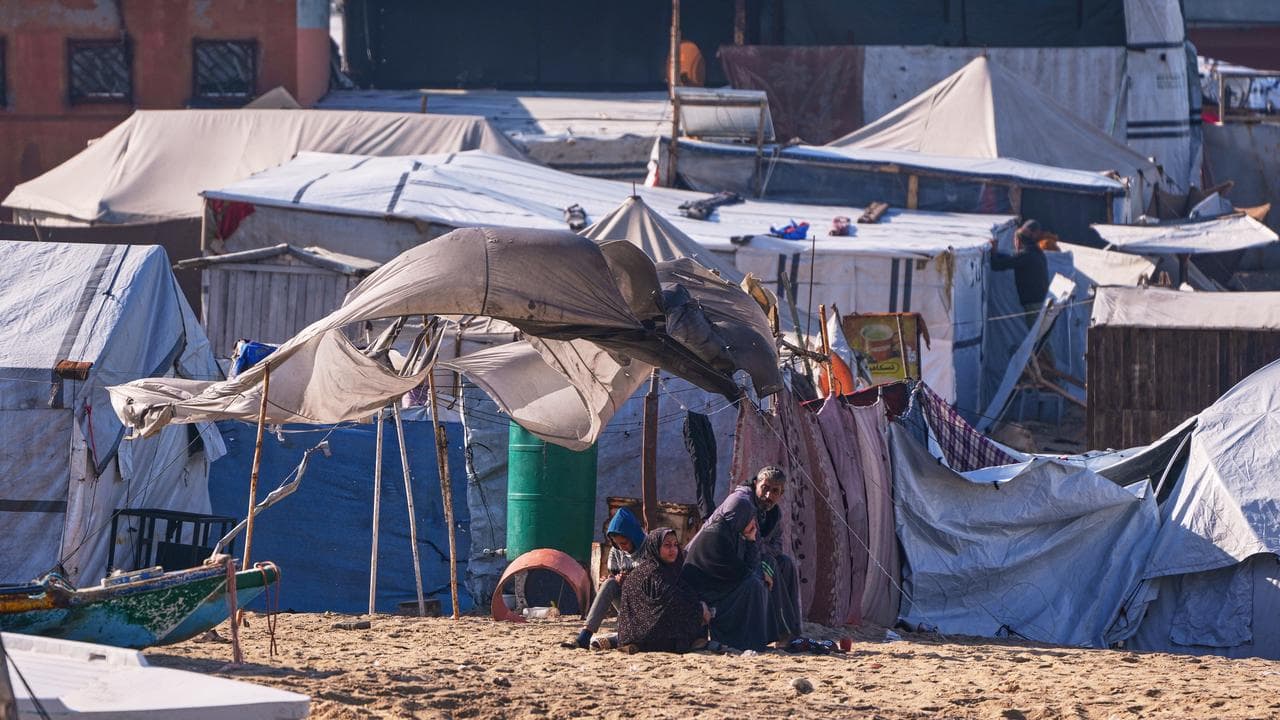 Displaced family outside their tent