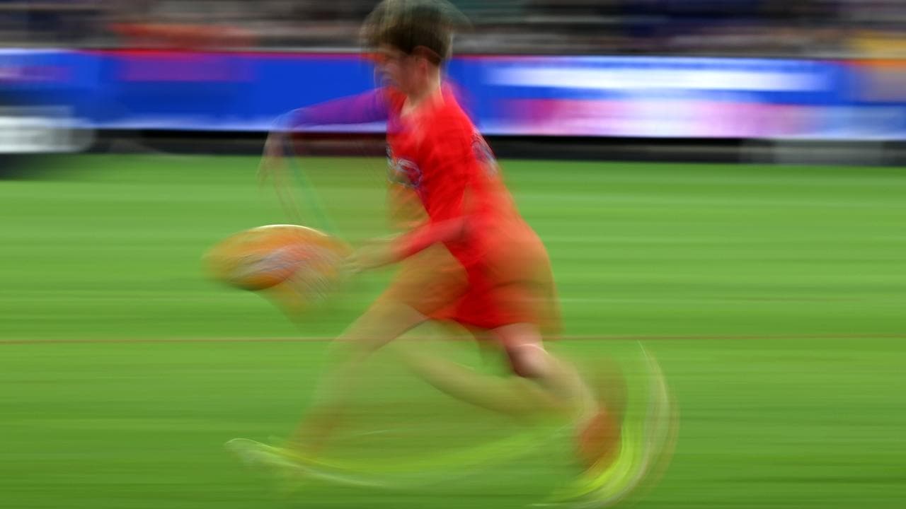 Stock image of kid playing football