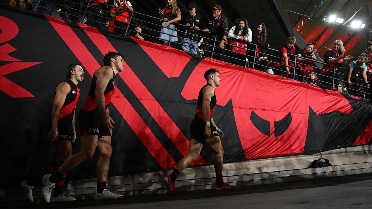 Essendon's Zach Merrett leads his team mates onto the field