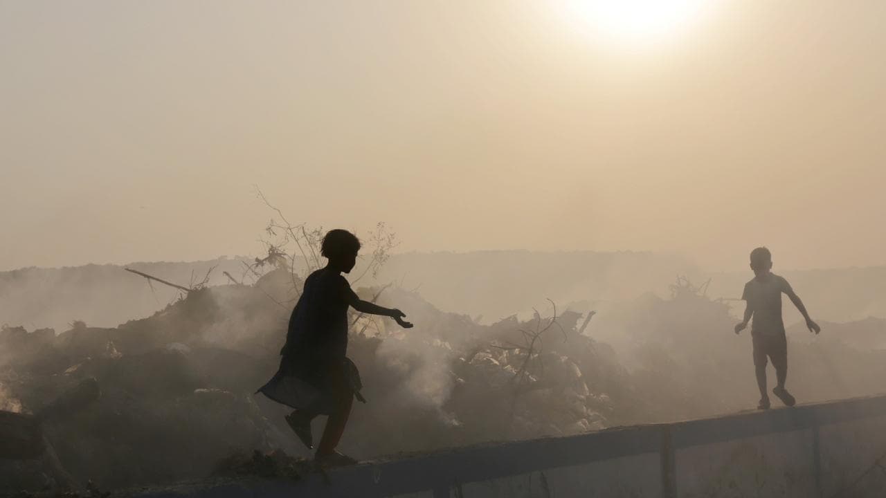A photo of Indian children playing in smog in Calcutta.