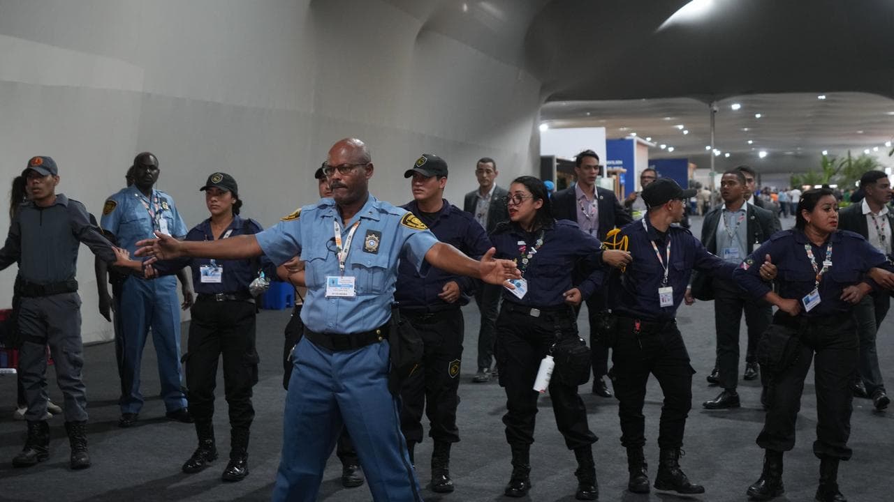 Security personnel form a chain