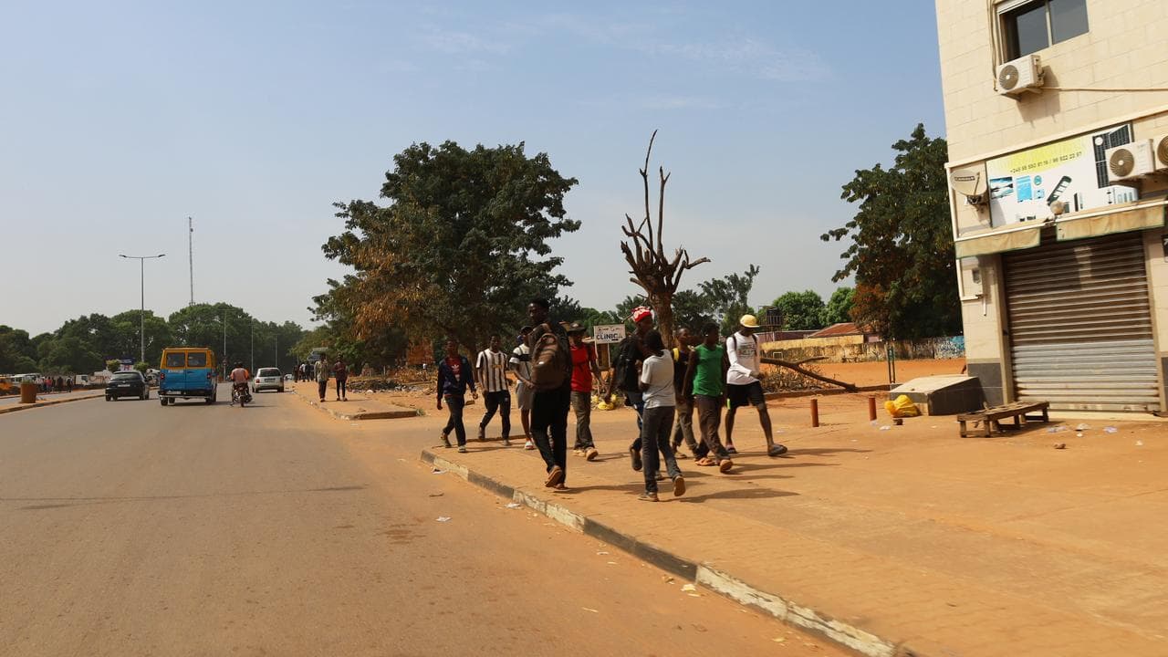 People walk on the street in Bissau