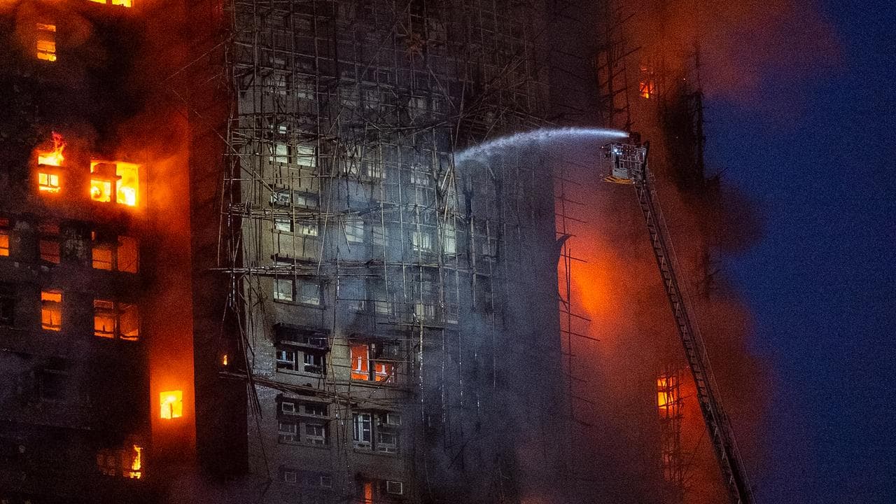 Firefighters work to extinguish a fire at Wang Fuk Court