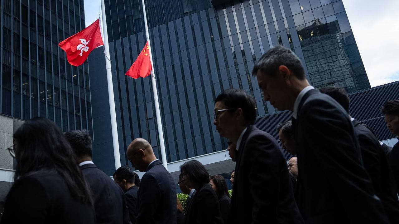 Chinese and Hong Kong flags fly at half-mast