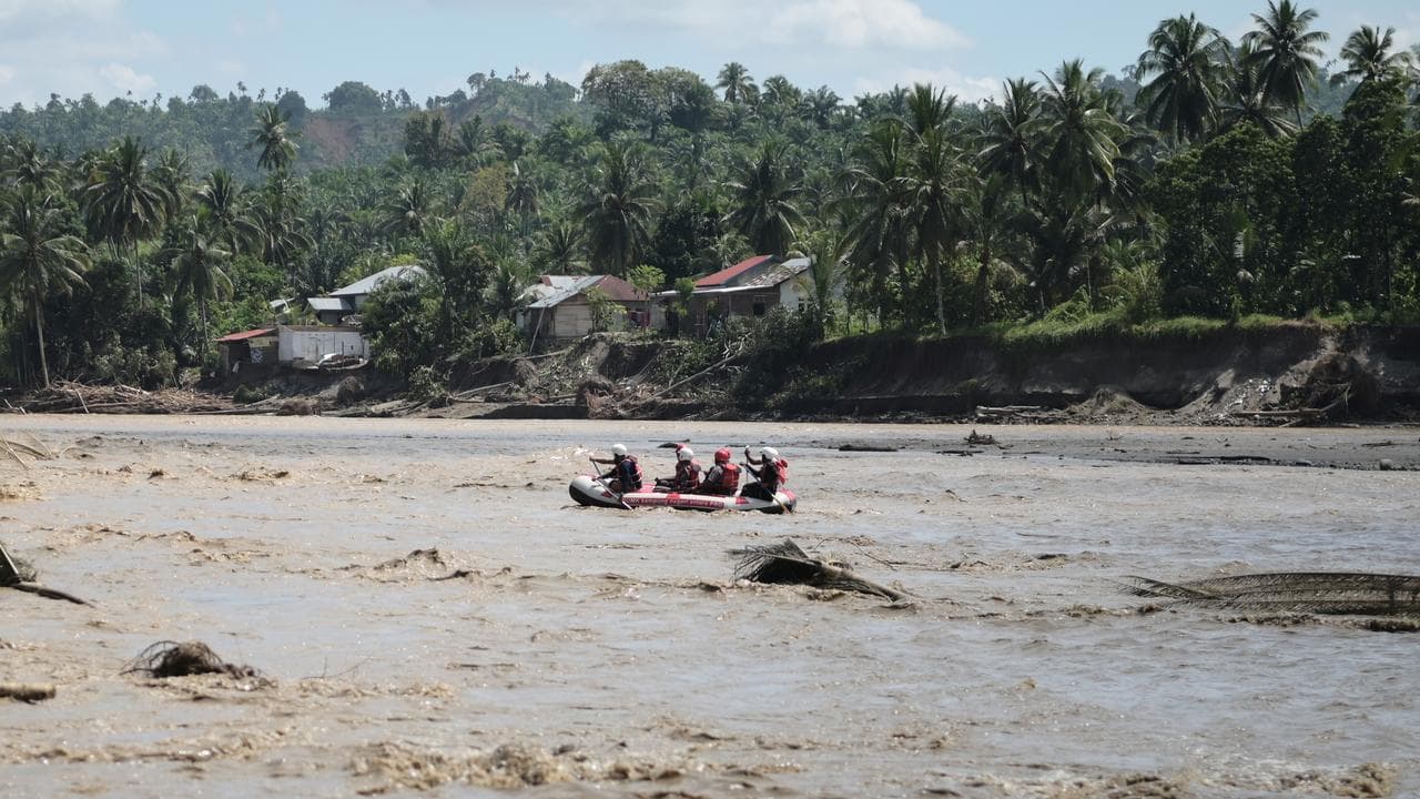 Rescuers use rubber boat during the search for missing people