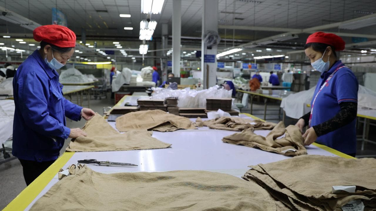 Workers labour at a textile manufacturer, in Binzhou in east China
