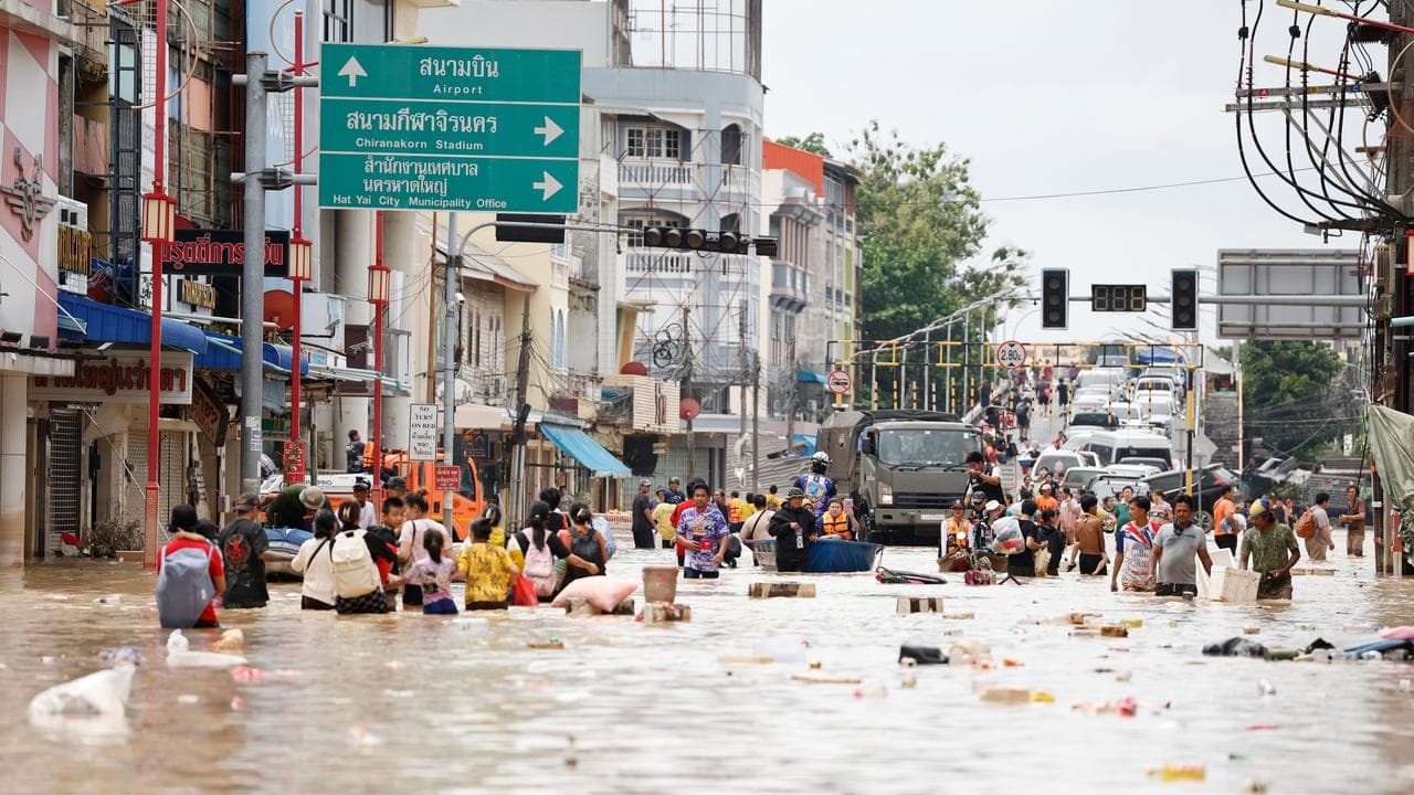 People wade through floodwaters in Songkhla province