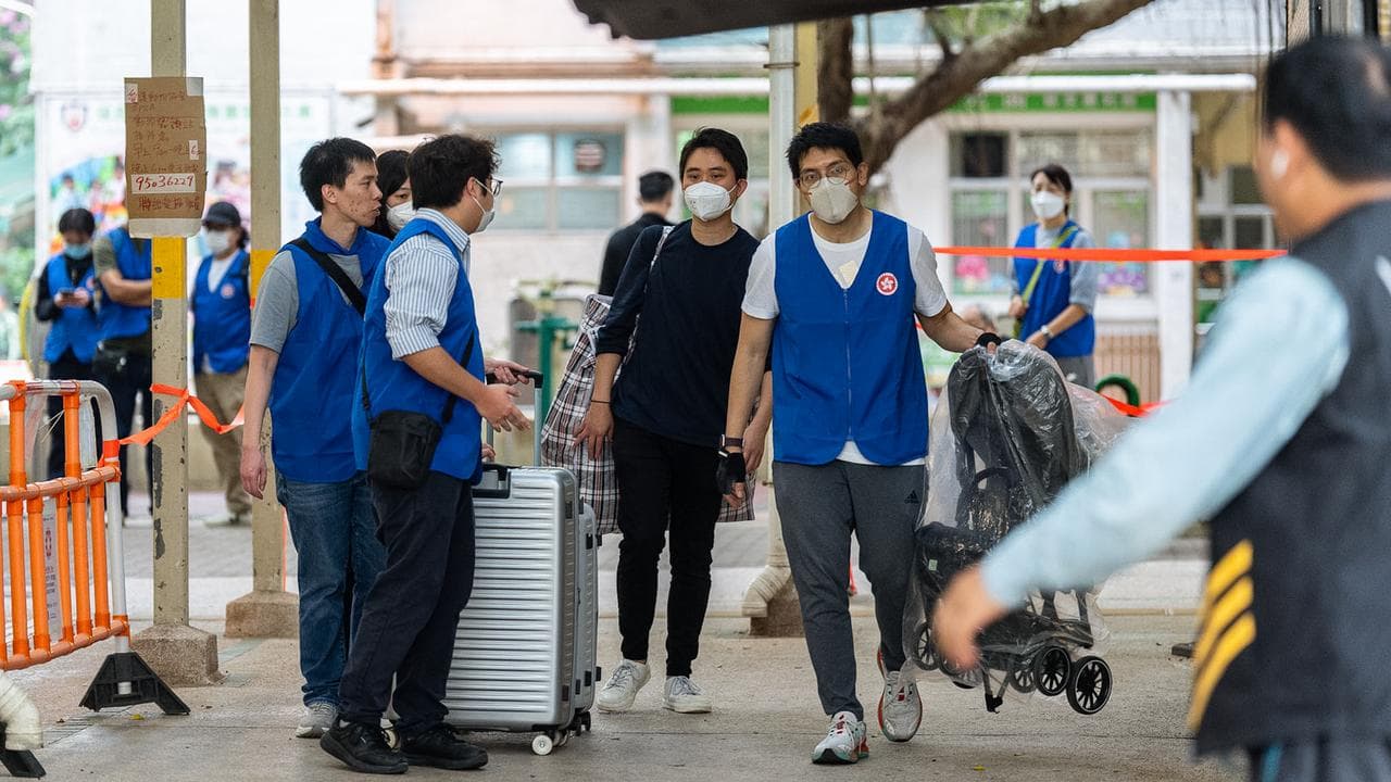 Residents return to collect belongings after a fire at Wang Fuk Court