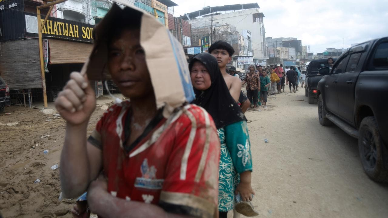 Survivors queue up for aid in Aceh Tamiang on Sumatra Island