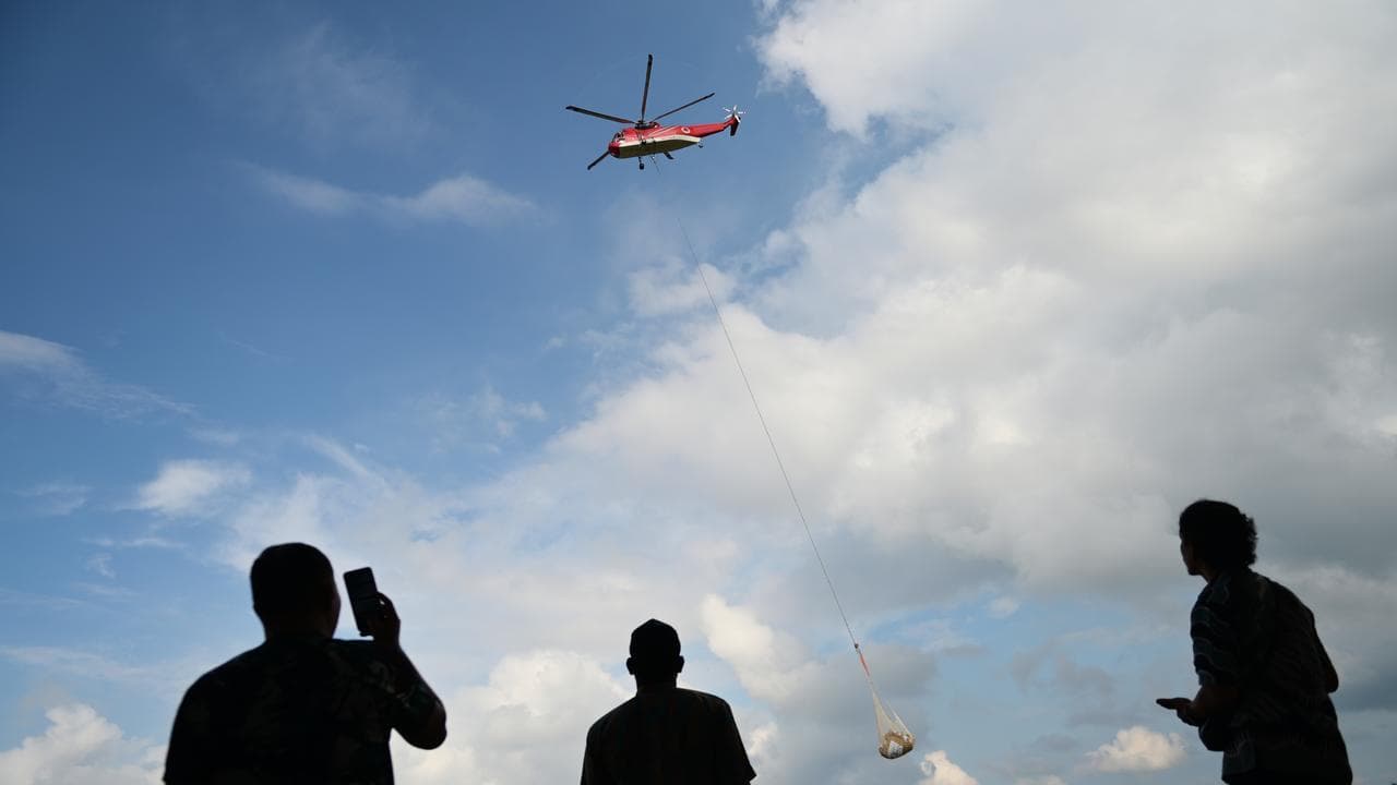Helicopter takes off with relief goods at Sultan Iskandar Muda Airbase