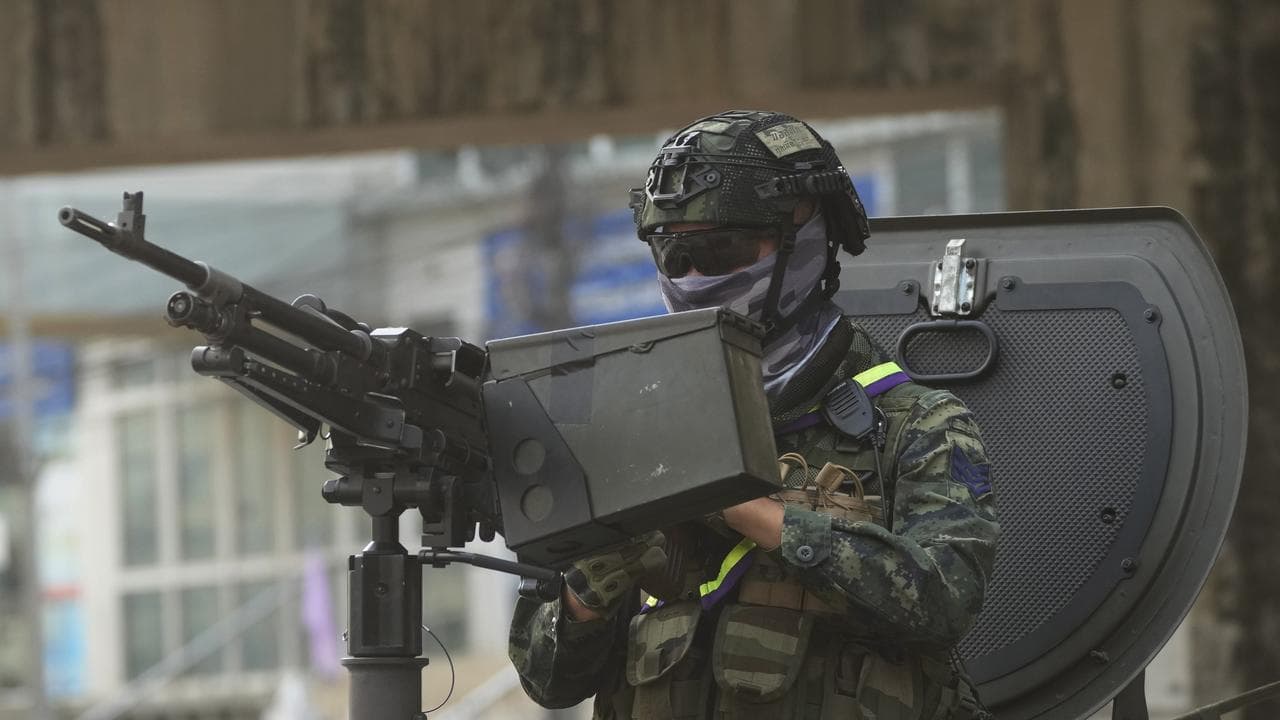 Thai military personnel on an armored vehicle