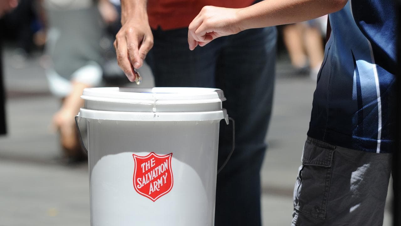 People put money in a charity bucket (file image)