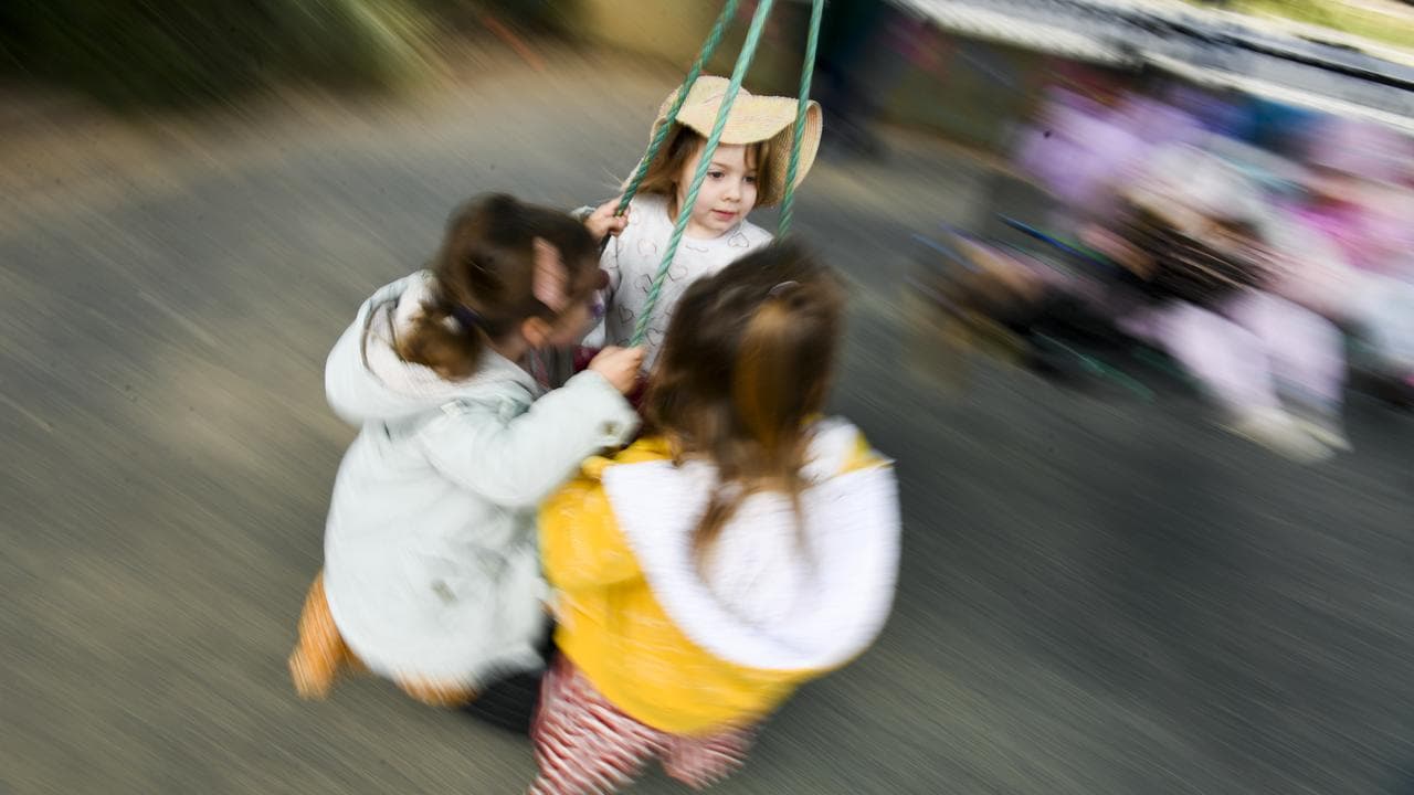 Girls play on a swing (file image)