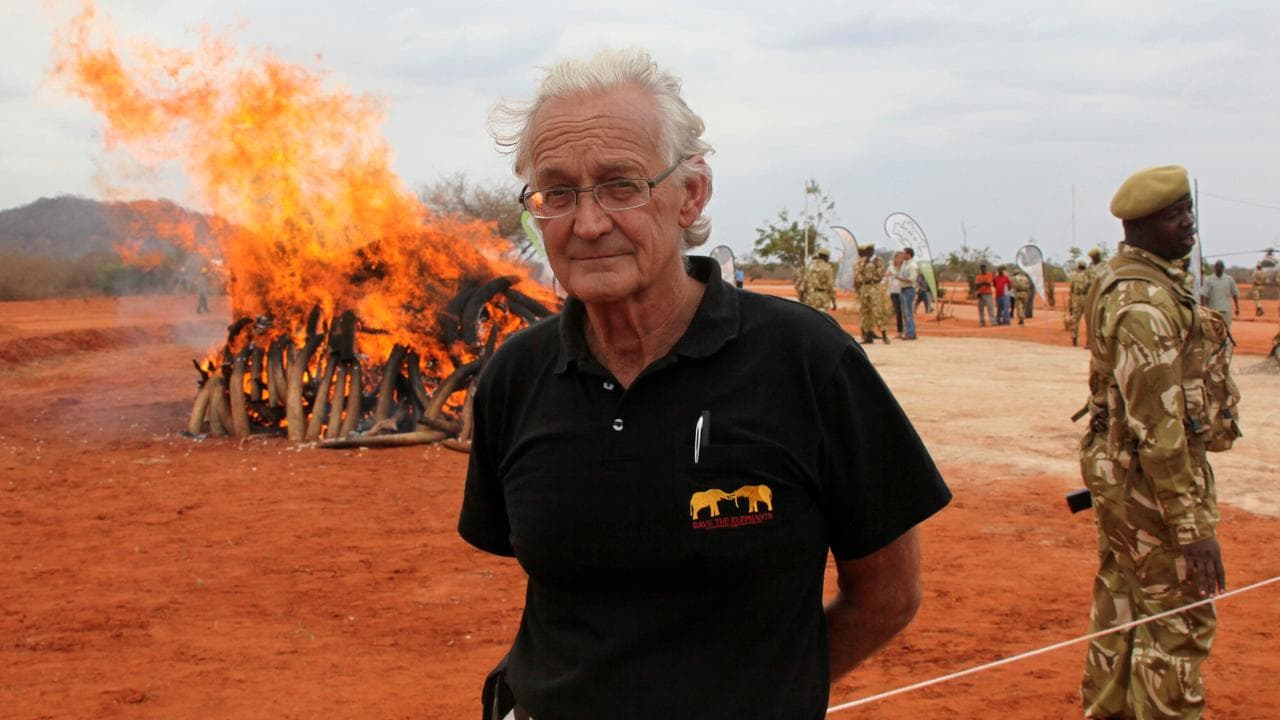 Iain Douglas-Hamilton poses in front of confiscated ivory