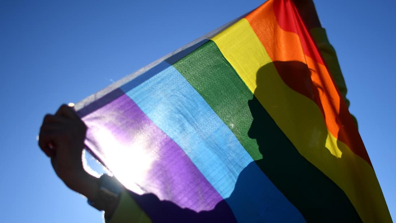 Someone holding a rainbow flag.