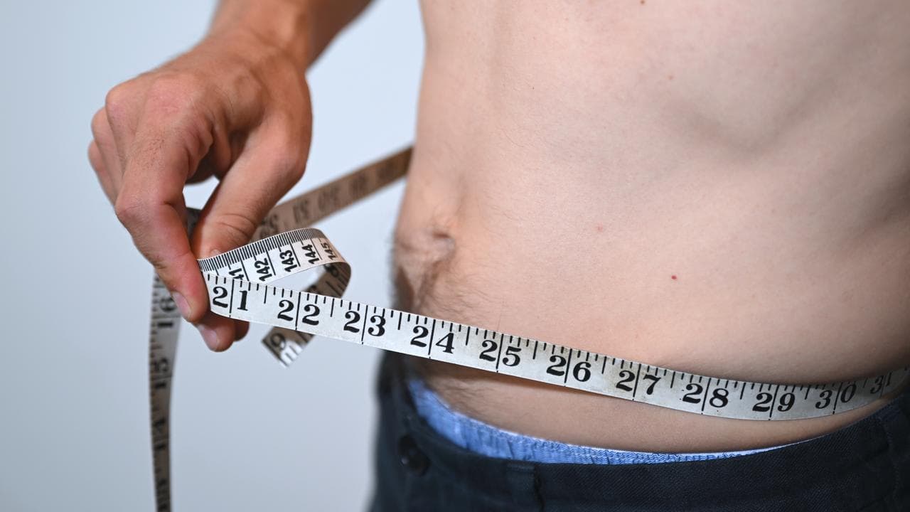 Man uses measuring tape