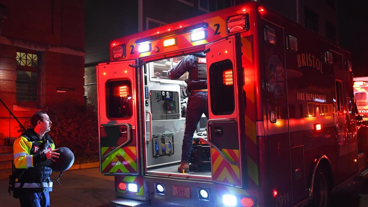 Emergency personnel step out of a vehicle near Brown University