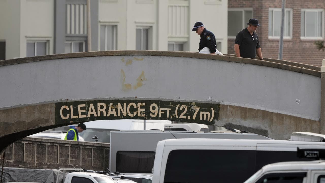 Police examine foot bridge.