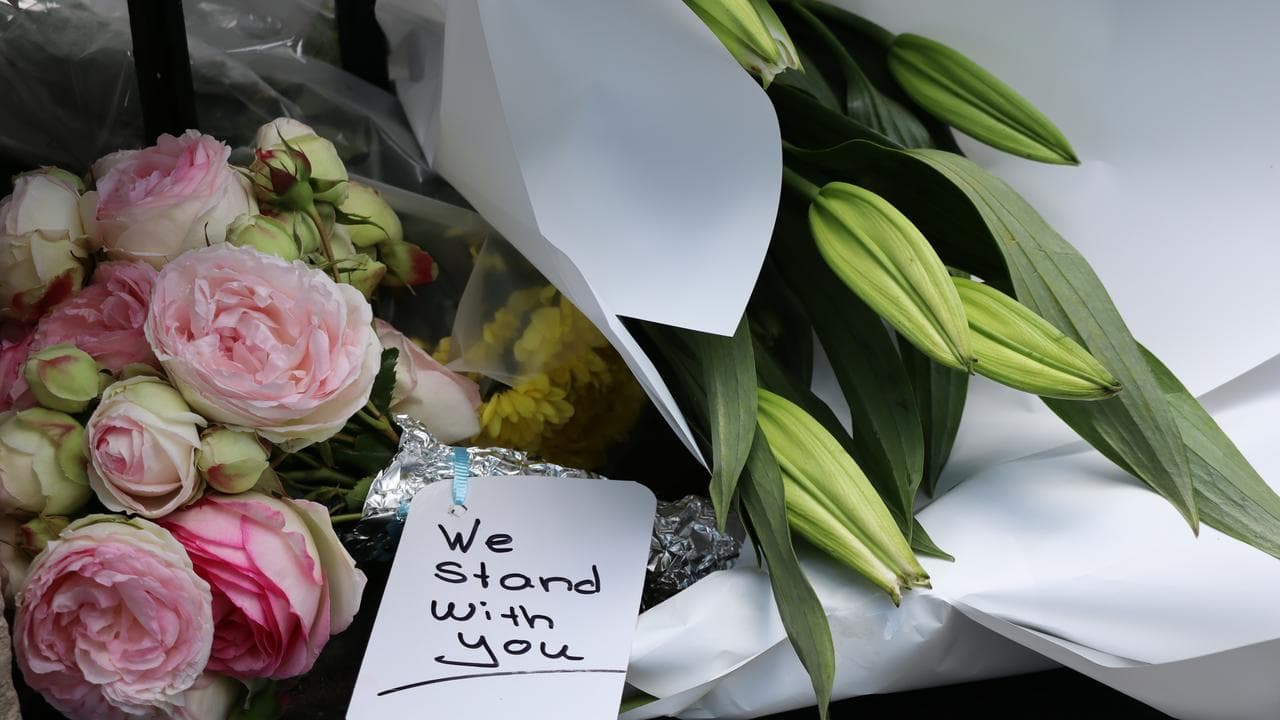 Flowers and messages of support outside the Hobart synagogue.