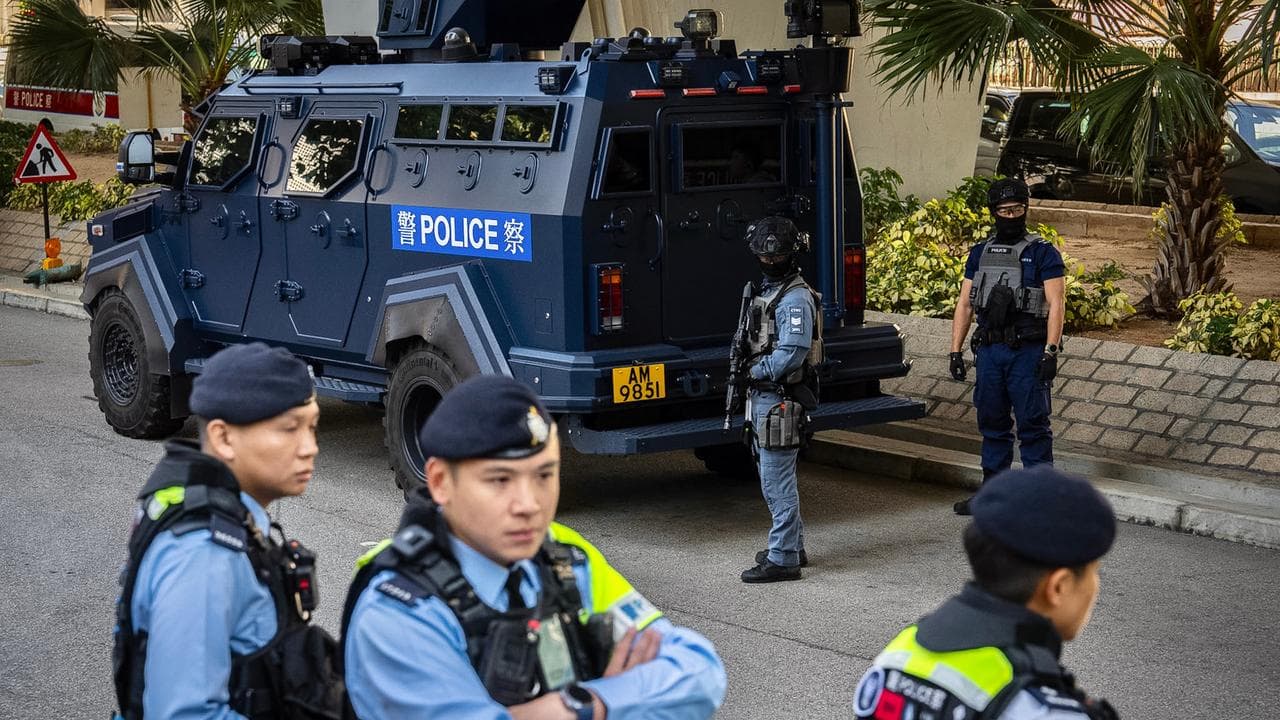 Armed police stand guard outside court