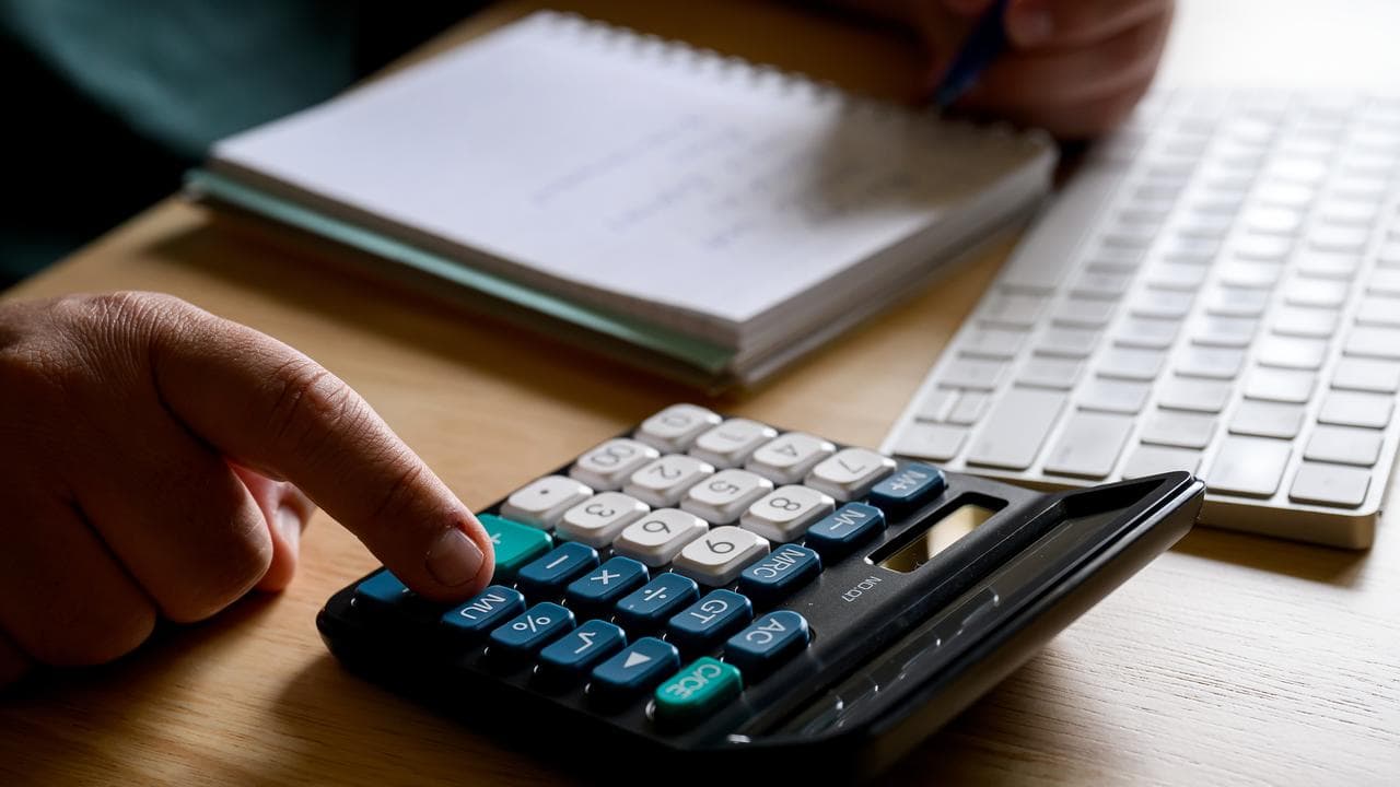 A person using a calculator (file image)