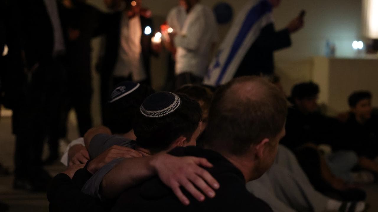Mourners at a makeshift memorial at Bondi Beach