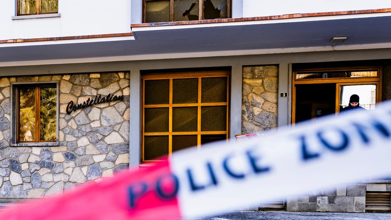Police inspect the area where a fire broke out at Le Constellation bar