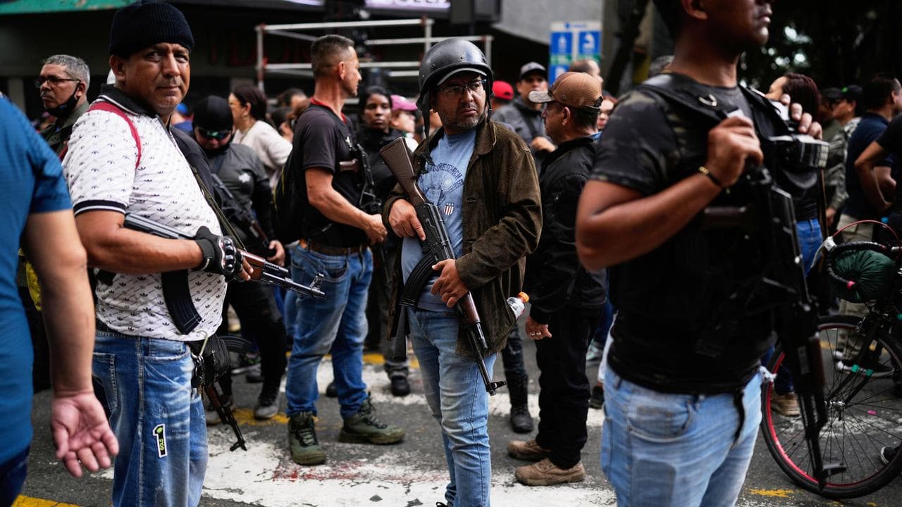 Pro-government armed civilians attend a protest in Caracas, Venezuela