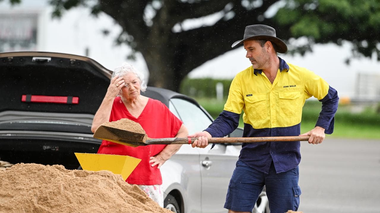 Local residents fill sandbags in preparation for severe weather