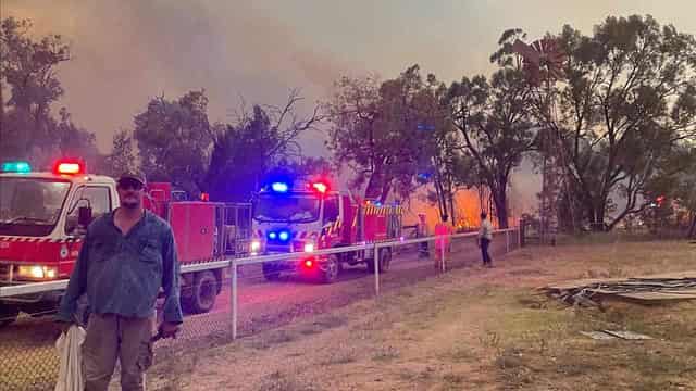 Buildings destroyed in big blaze as rain brings relief