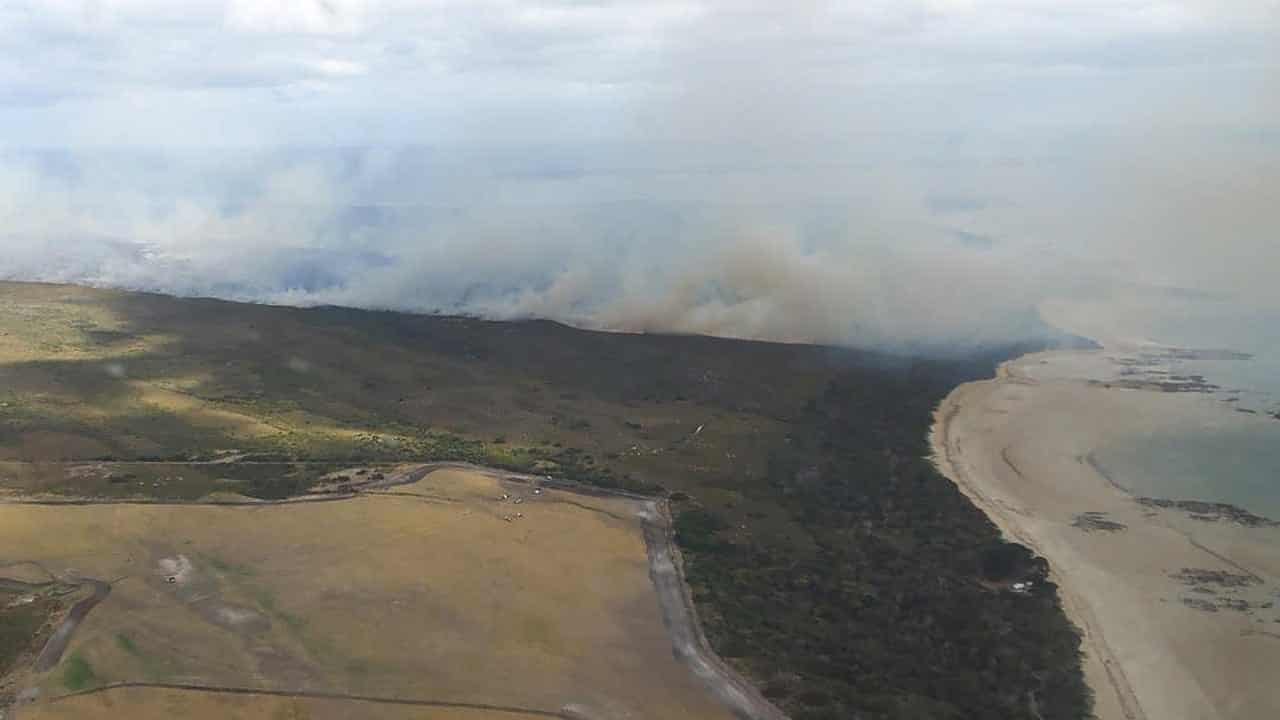 Bushfire downgraded after campers, residents evacuated