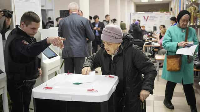 Russians vote as Ukraine attacks city, strikes refinery