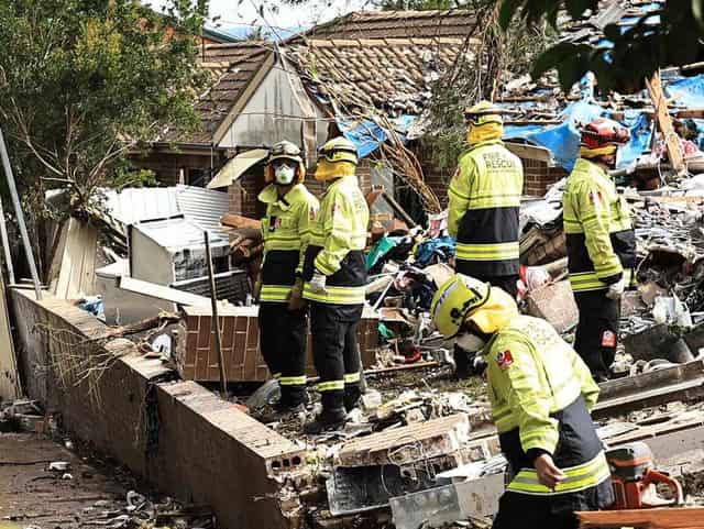 Race to free woman trapped beneath collapsed townhouse