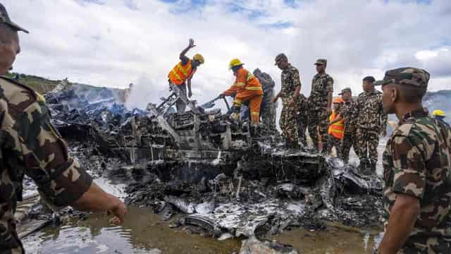 Plane slips off runway at Nepal airport, killing 18