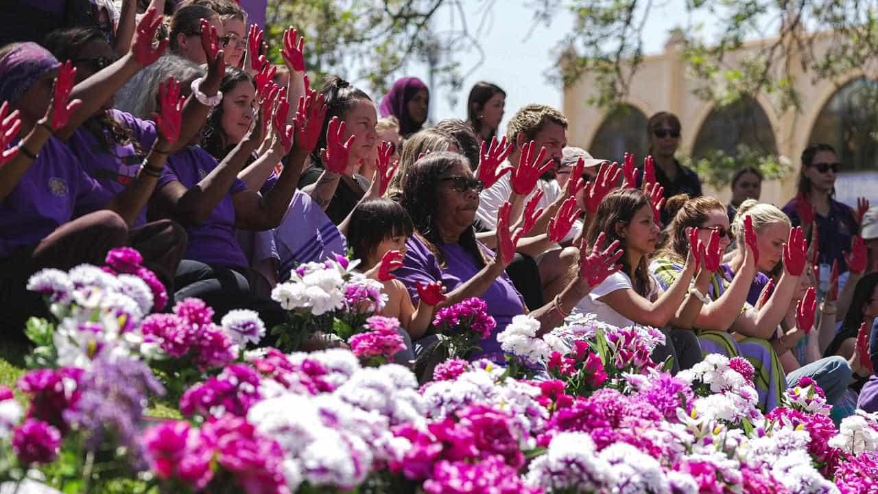 Raised hands in Red Centre as survivors call for change