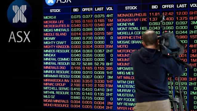 Aussie shares dip as banks drag, BHP and Woodside gain