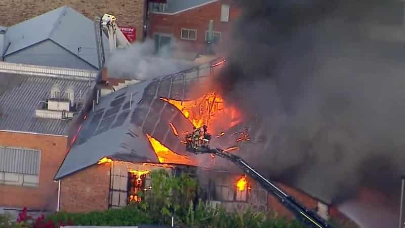 Brisbane blaze destroys building as man fights for life